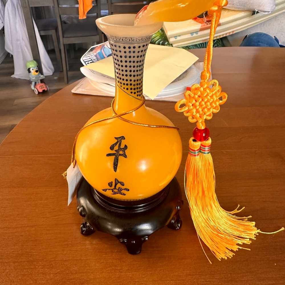 Elegant Orange Vase with Tassel Accent